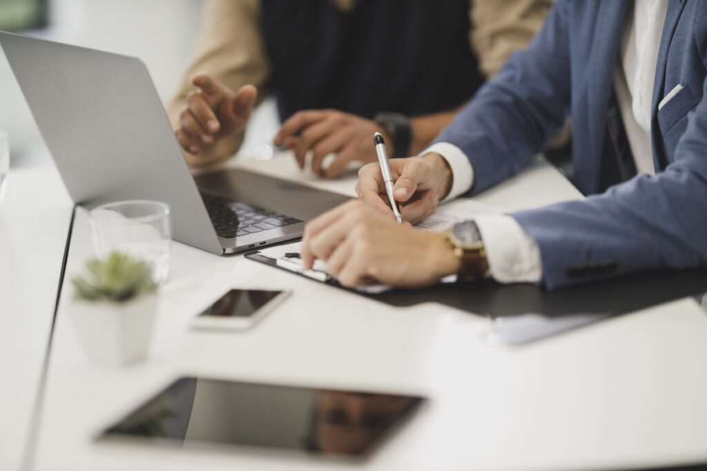 office workers checking papers with pen in office